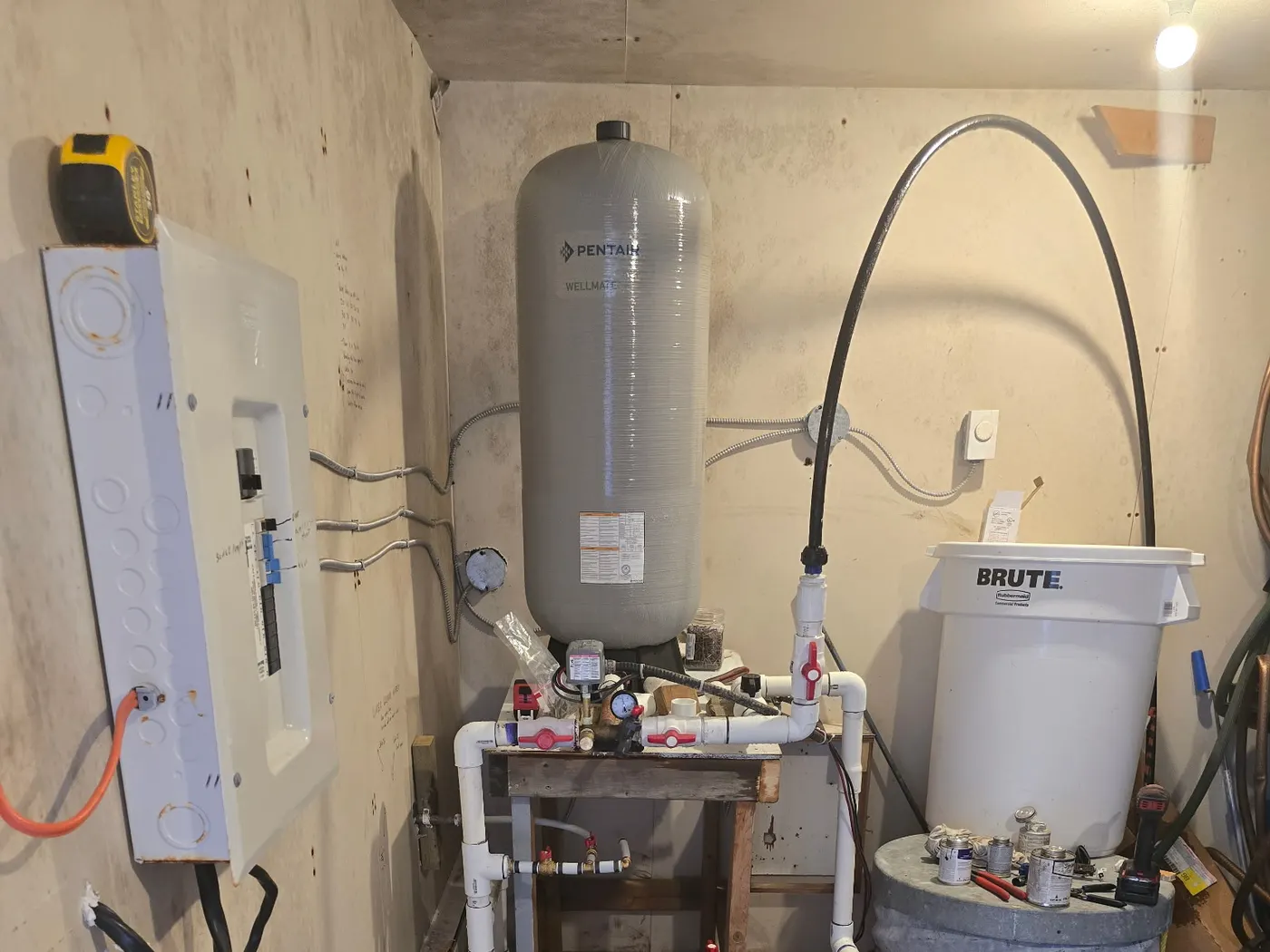 Acreage well water pressure tank and treatment piping