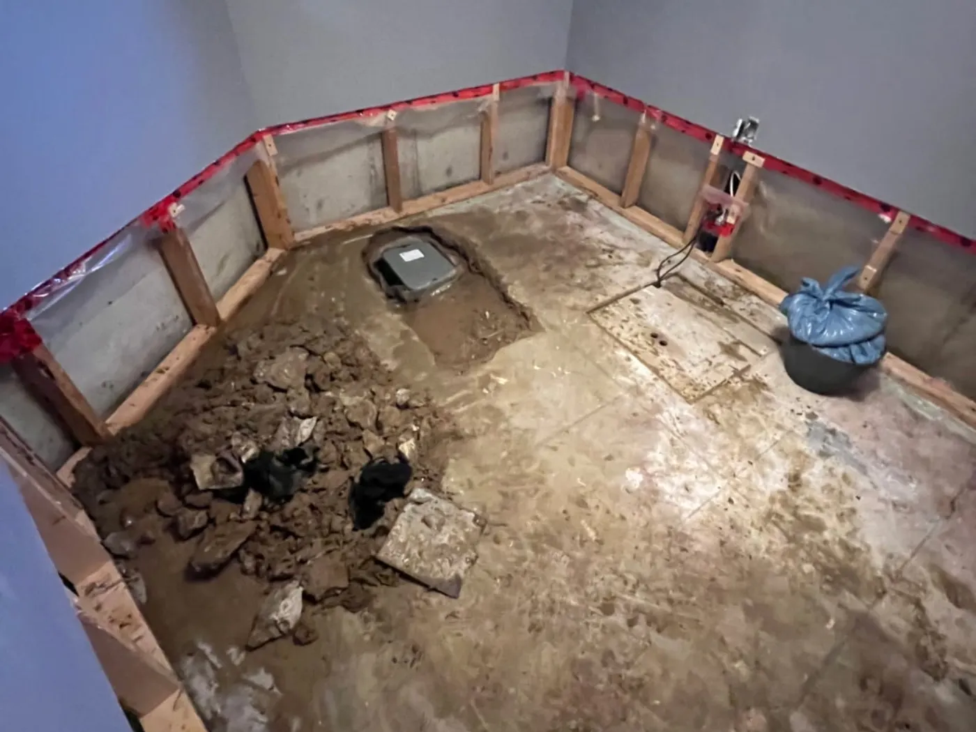 Basement weeping tile excavation prepared for a new sump system
