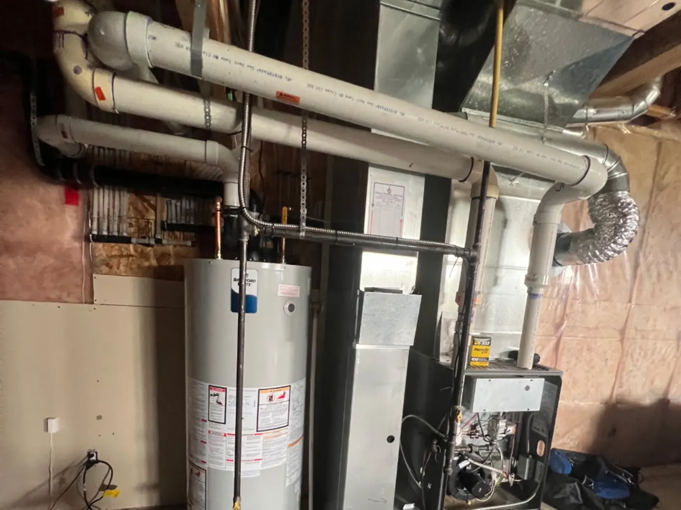 High-efficiency furnace and indoor coil cabinet in a residential mechanical room