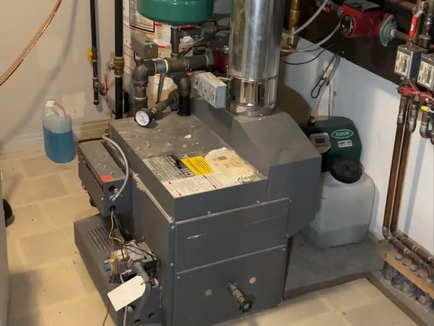 Technician servicing the internals of a residential boiler