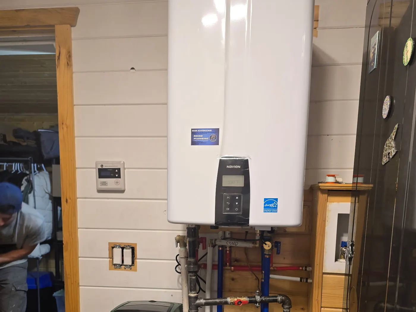 Wall-mounted tankless water heater installed by Rhino Plumbing