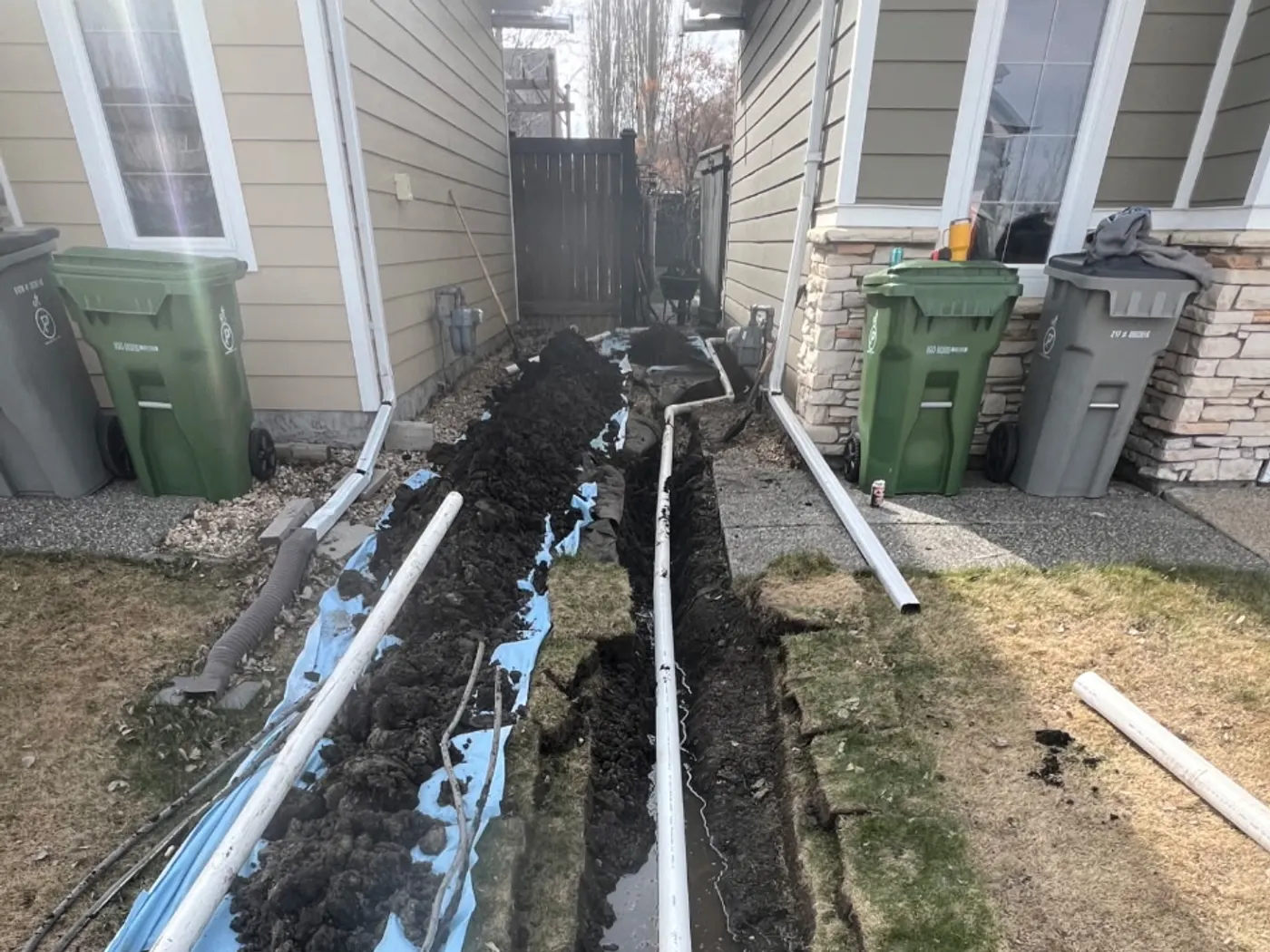 New underground sewer line laid in an open trench ready for backfill